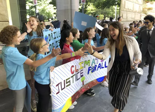 Kelsey Juliana, of Eugene, Ore., a lead plaintiff who is part of a lawsuit by a group of young people who say U.S. energy policies are causing climate change and hurting their future, greets supporters outside a federal courthouse, June 4, 2019, in Portland, Ore. A 9th U.S. Circuit Court of Appeals panel on Wednesday, May 1, 2024, rejected a long-running lawsuit brought by young Oregon-based climate activists who argued that the U.S. government's role in climate change violated their constitutio