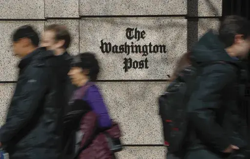 People walk by the One Franklin Square Building, home of The Washington Post newspaper, in downtown Washington, Feb. 21, 2019. (AP Photo/Pablo Martinez Monsivais, File)