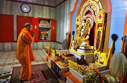 Uttar Pradesh Chief Minister Yogi Adityanath prays at a temple in the morning before going to file his nomination papers for the state assembly elections in Gorakhpur, India, Feb. 5, 2022. The polls are a referendum on the saffron-robed Adityanath, a poster figure for the Hindu right-wing, who some analysts believe is vying to be the next prime minister. Over 150 million people are expected to vote in the state across seven phases starting Thursday before results are declared in March. (AP Photo