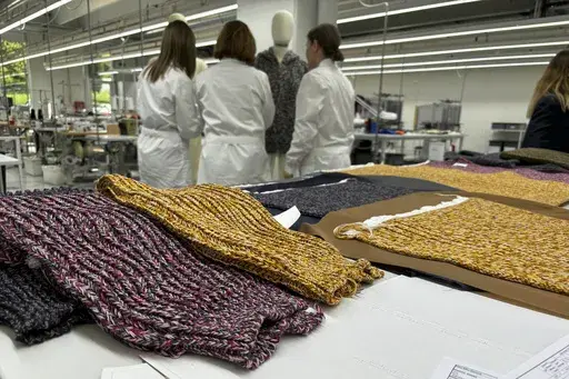 Knitwear created by Italian artisans for the Prada and Miu Miu brands sit on a desk at a recently expanded factory in the Perugia province of Italy, Tuesday, May 7, 2024. The Prada Group is expanding its production footprint in Italy, including dozens of new jobs at brand's knitwear factory near Umbria, leaning into Made in Italy as integral to the brand's ethos as it develops new artisanal talent to ease the luxury group through a generational shift in its workforce, alongside the management an