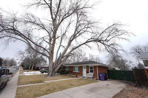 The residence where a former funeral home owner kept a deceased women's body in a hearse for two years as well as the remains of 30 cremated people is shown Friday, Feb. 16, 2024, in southwest Denver. The discovery occurred on Feb. 6 during a court-ordered eviction of the home rented by 33-year-old Miles Harford, who authorities have issued an arrest warrant for. (AP Photo/David Zalubowski)