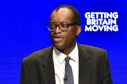 Britain's Chancellor of the Exchequer Kwasi Kwarteng speaks at the Conservative Party conference at the ICC in Birmingham, England, Monday, Oct. 3, 2022. The British government has dropped plans to cut income tax for top earners, part of a package of unfunded cuts that sparked turmoil on financial markets and sent the pound to record lows. (AP Photo/Rui Vieira)