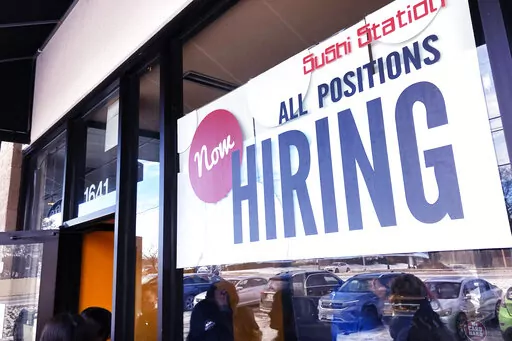 A hiring sign is displayed at a restaurant in Rolling Meadows, Ill., Tuesday, Dec. 27, 2022. (AP Photo/Nam Y. Huh)