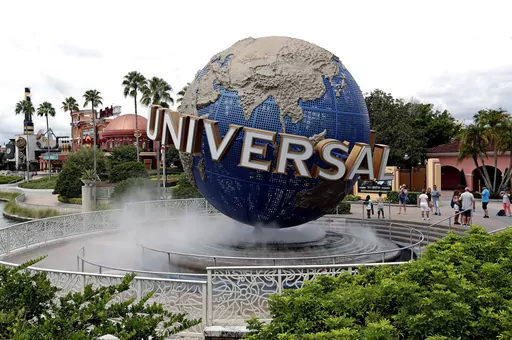 In this Aug. 5, 2019 file photo, guests cool off under a water mist by the globe at Universal Studios City Walk at Universal Studios Florida in Orlando, Fla. Universal Orlando Resort's new theme park opening next year will feature lands devoted to Super Nintendo World characters, the “Fantastic Beasts” films and the “How to Train Your Dragon” film franchise, theme park officials said Tuesday, Jan. 30, 2024. At the center of what will be Universal Orlando's fourth theme park, Universal Ep