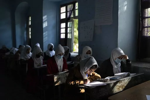 Afghan girls participate in a lesson at Tajrobawai Girls High School in Herat, Afghanistan on Nov. 25, 2021. In a surprise decision the hardline leadership of Afghanistan's new rulers has decided against opening educational institutions to girls beyond Grade six, a Taliban official said Wednesday, March 23, 2022 on the first day of Afghanistan's new school year. (AP Photo/Petros Giannakouris, File)