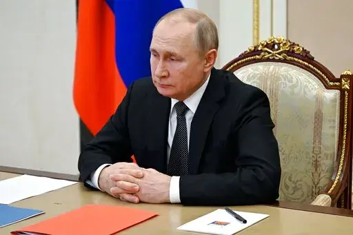 Russian President Vladimir Putin chairs a Security Council meeting via video conference at the Novo-Ogaryovo residence outside Moscow, Russia, Friday, Feb. 18, 2022. (Mikhail Klimentyev, Sputnik, Kremlin Pool Photo via AP)