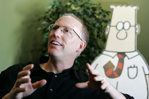 Scott Adams, creator of the comic strip Dilbert, talks about his work at his studio in Dublin, Calif., on Oct. 26, 2006. Adams experienced possibly the biggest repercussion of his recent comments about race when distributor Andrews McMeel Universal announced Sunday, Feb. 26 it would no longer work with the cartoonist. In an episode of his YouTube show last week, Adams described people who are Black as members of “a hate group” from which white people should “get away.” Various media publ