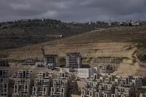 This photo shows a construction site of new housing projects in the West Bank Israeli settlement of Givat Ze'ev, Monday, June 18, 2023. The population of Israeli settlers in the occupied West Bank grew nearly 3% in 2023, according to a new report based on population statistics from the Israeli government. The report, released Sunday Feb. 11, 2024 by the pro-settler group WestBankJewishPopulationStats.com, found the settler population jumped to 517,407 as of Dec. 31, from 502,991 a year earlier. 