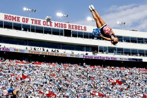 A cheerleader from the University of Mississippi performs a flip before the first half of an NCAA college football game against Oklahoma University on Saturday, Oct. 26, 2024, in Oxford, Miss. (AP Photo/Sarah Warnock)