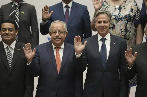 Guatemalan Foreign Minister Carlos Ramiro Martinez Alvarado, left, and U.S. Secretary of State Antony Blinken pose for a group photo at the National Palace in Guatemala City, Tuesday, May 7, 2024. Blinken is in Guatemala for a two-day visit where he will attend a regional meeting on irregular migration. (AP Photo/Moises Castillo)