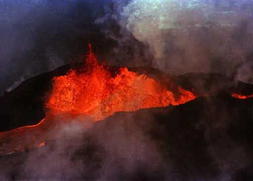Molten rock flows from Mauna Loa on March 28, 1984, near Hilo, Hawaii. Hawaii officials are warning residents of the Big Island to prepare for the possibility that the world's largest active volcano may erupt given a recent spike in earthquakes at the summit of Mauna Loa. Scientists don't expect the volcano to erupt imminently, but officials are reminding people lava could reach some homes in just a few hours when it does. (AP Photo/Ken Love, File)