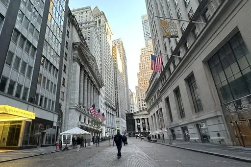 American flags, left, hang from the New York Stock Exchange on Oct. 16, 2024, in New York. (AP Photo/Peter Morgan, File)