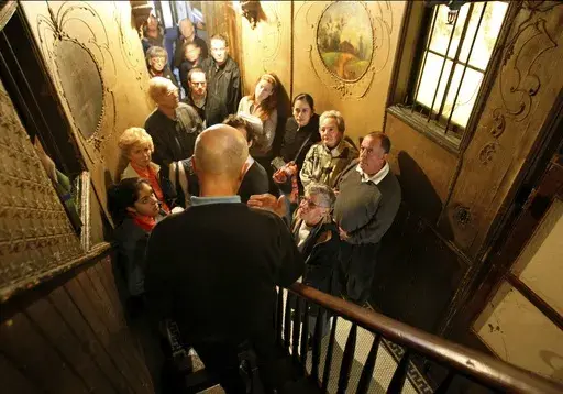 A guide leads a tour at the Tenement Museum on the Lower East Side in New York, on Oct. 7, 2008. (AP Photo/Kathy Willens, File)