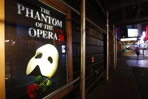 A poster advertising "The Phantom of the Opera," is displayed on the shuttered Majestic Theatre in New York, March 12, 2020. Broadway's longest-running show will play its final performance on Broadway on Feb. 18, 2023, a spokesperson told The Associated Press on Friday, Sept. 16, 2022. The closing will come less than a month after its 35th anniversary. (AP Photo/Kathy Willens, File)