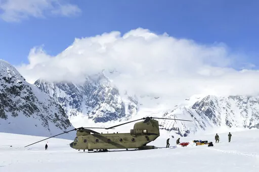 In this photo provided by the U.S. Army, soldiers and National Park Service personnel offload equipment and supplies from a CH-47 Chinook helicopter on Kahiltna Glacier, Alaska, on Wednesday, April 27, 2022. Those wishing to climb North America's tallest peak got a boost this week from the U.S. Army. Aviators from B Company, 1st Battalion, 52nd Aviation Regiment at Fort Wainwright flew two helicopters Wednesday to continue the decades-old tradition of helping set up base camp on Denali, a 20,310