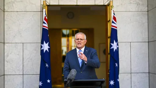 Australian Prime Minister Scott Morrison gestures during a news conference at Parliament House in Canberra, Australia, Sunday, April 10, 2022. Morrison has called for a May 21 election that will be fought on issues including Chinese economic coercion, climate change and the COVID-19 pandemic. (Lukas Coch/AAP Image via AP)