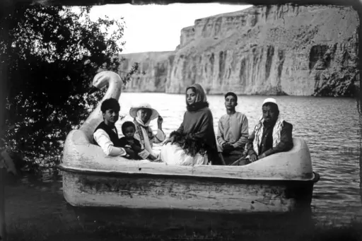 The Moradi family sits for a portrait on a small boat in Band-i-Mir lake, one of the tourist attractions in the Bamiyan Valley region in Afghanistan, Saturday, June 17, 2023. The family traveled a long way from Helmand to spend a few days for their summer vacation. During their first stint in power from 1996 to 2001, the Taliban banned photography of humans and animals as contrary to the teachings of Islam. Many box cameras were smashed, though some were quietly tolerated, Afghan photographers s