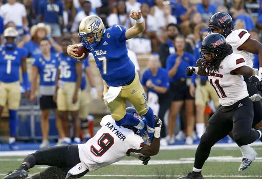 Tulsa quarterback Davis Brin tries to get away from Northern Illinois' Daveren Rayner during an NCAA college football game Saturday, Sept. 10, 2022, in Tulsa, Okla. (Stephen Pingry/Tulsa World via AP)