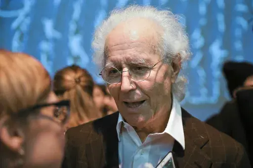 Luciano Benetton speaks to guests after the Benetton women's Fall-Winter 2019-2020 collection, that was presented in Milan, Italy, on Feb.19, 2019. Benetton, a co-founder of the apparel brand, announced he was stepping down as chairman in an interview Saturday May 25, 2024 with the Milan daily Corriere della Sera where he blamed current management for losses of 100 million euros ($108.5 million) that he discovered last year. (AP Photo/Luca Bruno, File)