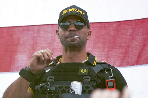 Proud Boys leader Henry "Enrique" Tarrio wears a hat that says The War Boys during a rally in Portland, Ore., on Sept. 26, 2020. A barrage of bickering between lawyers and the judge has bogged down the seditious conspiracy trial of former Proud Boys leader Enrique Tarrio and four associates. Defense attorneys have repeatedly argued in vain for the judge to declare a mistral. (AP Photo/Allison Dinner, File)