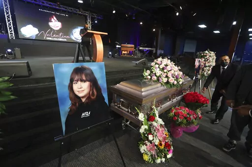 The casket containing 14-year-old Valentina Orellana-Peralta, killed on Dec. 23, 2021 by a LAPD police officer's stray bullet while shopping with her mother, is readied for her funeral at the City of Refuge Church in Gardena, Calif., Monday, Jan. 10, 2022. (AP Photo/David Swanson)