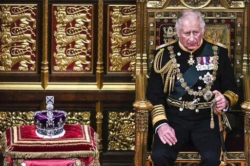 Britain's Prince Charles sits by the The Imperial State Crown in the House of Lords Chamber, during the State Opening of Parliament, in the Houses of Parliament, in London, Tuesday, May 10, 2022. Britain’s Conservative government made sweeping promises to cut crime, improve health care and revive the pandemic-scarred economy as it laid the laws it plans in the next year in a tradition-steeped ceremony known as the Queen’s Speech -- but without a key player, Queen Elizabeth II, absent for the
