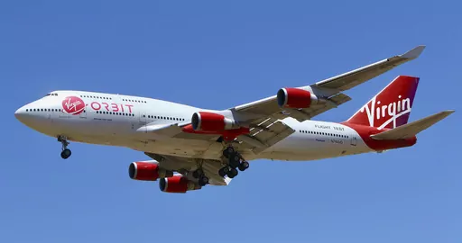 A Virgin Orbit Boeing 747-400 aircraft named Cosmic Girl prepares to land back at Mojave Air and Space Port in the desert north of Los Angeles Monday, May 25, 2020. Richard Branson's Virgin Orbit is slashing 85% of its workforce, Friday, March 31, 2023, after running into problems with funding less than four months after a mission of the satellite launching company failed. (AP Photo/Matt Hartman)