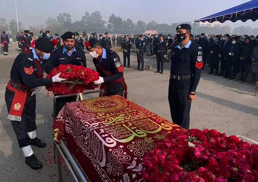 FILE- Police officers attend the funeral prayer of a colleague who was killed in an overnight attack by Pakistani Taliban who targeted police in multiple attacks in Islamabad and elsewhere in the country's northwest, in Islamabad, Pakistan, Jan. 18, 2022. Faced with rising violence, Pakistan is taking a tougher line to pressure Afghanistan’s Taliban rulers to crack down on militants hiding on their soil, but so far the Taliban remain reluctant to take action -- trying instead to broker a peace