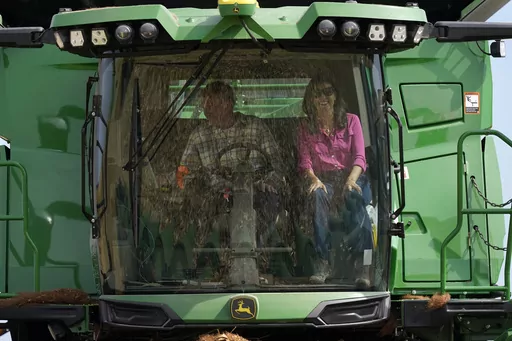 Republican presidential candidate former U.N. Ambassador Nikki Haley rides in a combine with farmer Dennis Campbell, left, during a tour of the Crystal Creek Enterprises farm, Friday, Sept. 15, 2023, in Grand Mound, Iowa. (AP Photo/Charlie Neibergall, File)