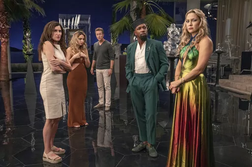 This image released by Netflix shows Kathryn Hahn, from left, Madelyn Cline, Edward Norton, Leslie Odom Jr. and Kate Hudson in a scene from "Glass Onion: A Knives Out Mystery."  (John Wilson/Netflix via AP)