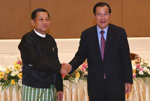 In this photo provided by An Khoun Sam Aun/National Television of Cambodia, Cambodian Prime Minister Hun Sen, right, shakes hands with Myanmar State Administration Council Chairman, Senior General Min Aung Hlaing, left, during after a meeting in Naypyitaw, Myanmar, Friday Jan. 7, 2022. Cambodian Prime Minister Hun Sen's visit to Myanmar seeking to revive peace efforts after last year's military takeover has provoked an angry backlash among critics, who say he is legitimizing the army's seizure o