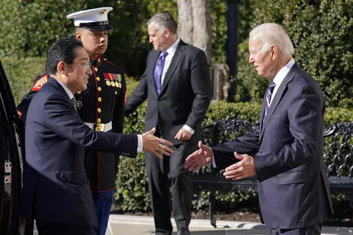President Joe Biden greets Japanese Prime Minister Fumio Kishida on the South Lawn of the White House, Friday, Jan. 13, 2023, in Washington. (AP Photo/Evan Vucci)