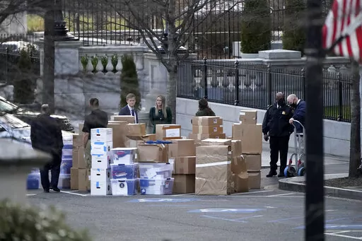 People wait for a moving van after boxes were moved out of the Eisenhower Executive Office building inside the White House complex, on Jan. 14, 2021, in Washington. A congressional oversight committee has sought additional documents from the National Archives related to former President Donald Trump's handling of White House records as the panel looks to expand its investigation into his handling of sensitive and even classified information. (AP Photo/Gerald Herbert, File)