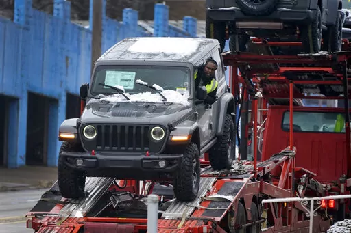 A new Jeep is delivered to a dealership in Pittsburgh on Monday, Jan. 23, 2023. On Friday, the Commerce Department issues its December report on consumer spending. (AP Photo/Gene J. Puskar)