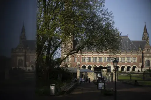 The Peace Palace housing the World Court, or International Court of Justice, is reflected in a monument in The Hague, Netherlands, Wednesday, May 1, 2024. (AP Photo/Peter Dejong, File)