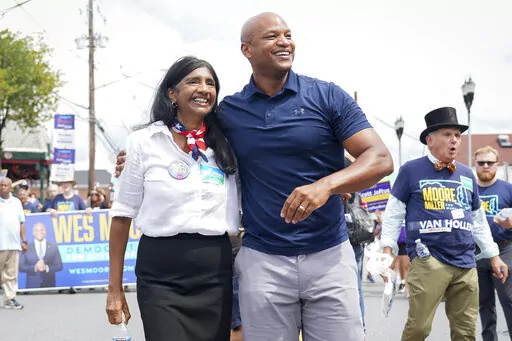 Maryland's Democratic gubernatorial nominee Wes Moore, right, and lieutenant governor nominee Aruna Miller walk together during a Labor Day parade in Gaithersburg, Md., on Sept. 5, 2022. Moore could soon make history if elected Maryland's first Black governor, and he's not alone: Rep. Anthony Brown would be the state's first Black attorney general. Miller would be Maryland's first immigrant lieutenant governor, and the first Asian-American elected statewide. (AP Photo/Bryan Woolston, File)