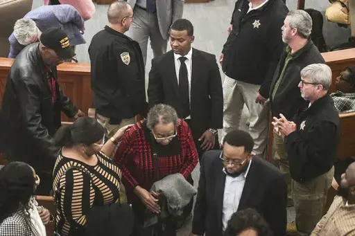 Sheldon "Timothy" Herrington Jr., center, who was on trial for the murder of University of Mississippi student Jimmie "Jay" Lee, joins family as they leave court after a mistrial was declared, at the Lafayette County Courthouse in Oxford, Miss. on Wednesday, Dec. 11, 2024. (Bruce Newman/The Northeast Mississippi Daily Journal, via AP, Pool)