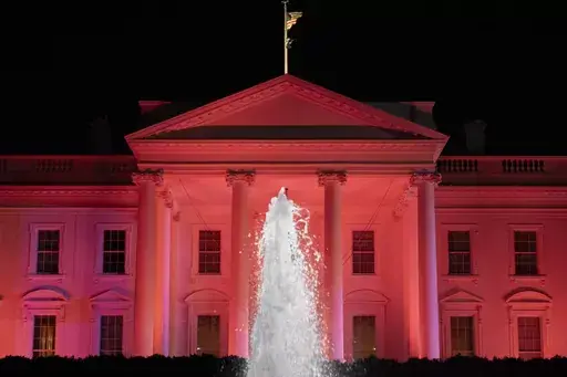 The White House is illuminated in pink for Breast Cancer Awareness Month, Thursday, Oct. 19, 2023, in Washington. (AP Photo/Andrew Harnik)