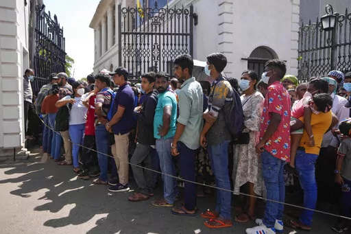 People queue up to enter the official residence of president Gotabaya Rajapaksa three days after it was stormed by anti government protesters in Colombo, Sri Lanka, Tuesday, July 12, 2022. Rajapaksa had vacated the building before the protesters came in. (AP Photo/Eranga Jayawardena)