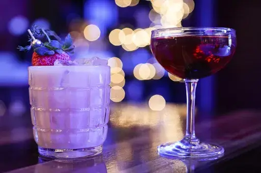 Mixed drinks are displayed at a bar in Baltimore on Wednesday, Feb. 8, 2023. (AP Photo/Julio Cortez, File)
