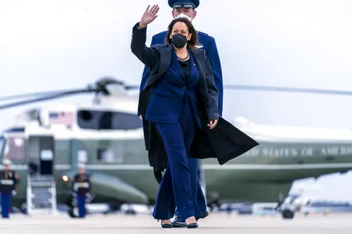 Vice President Kamala Harris, escorted by Maj Guy Evertson, Alt. Director Flight Line Protocol, C-32A Pilot, walks across the tarmac to board her plane at Andrews Air Force Base, Md., Thursday, Feb. 17, 2022, to travel to Munich for the Munich Security Conference. (AP Photo/Andrew Harnik, Pool)