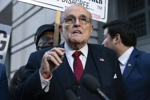 Rudy Giuliani speaks during a news conference outside federal court in Washington, Dec. 15, 2023. On Friday, July 12, 2024, a federal judge threw out the bankruptcy case of the former New York mayor, citing repeated “uncooperative conduct,” including a failure to comply with court orders and disclose sources of income. (AP Photo/Jose Luis Magana, File)