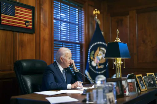 In this file image provided by The White House, President Joe Biden speaks with Russian President Vladimir Putin on the phone from his private residence in Wilmington, Del., Dec. 30, 2021. Biden acknowledged on Thursday that a document with classified markings from his time as vice president was found in his “personal library” at his home in Wilmington, Delaware, along with other documents found in his garage, days after it was disclosed that sensitive documents were also found at the office