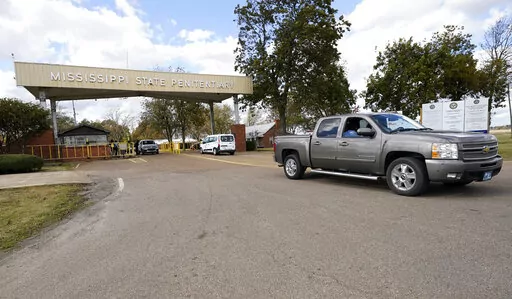 The front gate of the Mississippi State Penitentiary in Parchman, Miss., is shown Nov. 17, 2021. The U.S. Justice Department says it has found "severe, systemic" problems at the Mississippi State Penitentiary at Parchman. The department on Wednesday, April 20, 2022, released findings of its two-year investigation of Parchman, which began after an outburst of violence that left some inmates dead and others injured.  (AP Photo/Rogelio V. Solis, File)