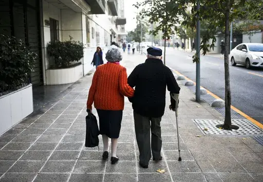 A couple walk on a sidewalk in Santiago, Chile, Wednesday on May 3, 2017. (AP Photo/Esteban Felix, File)
