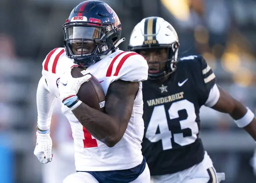 Mississippi wide receiver Jonathan Mingo (1) races up the field with a 71-yard touchdown reception, past Vanderbilt linebacker De'Rickey Wright (43) during the third quarter of an NCAA college football game Saturday, Oct. 8, 2022, in Nashville, Tenn. (George Walker IV/The Tennessean via AP)