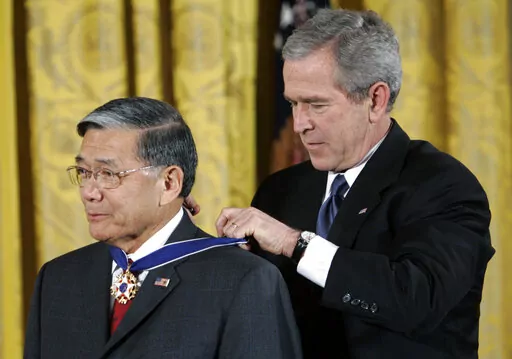 President Bush, right, bestows the Presidential Medal of Freedom to former Transportation Secretary Norman Y. Mineta during a ceremony in the East Room of the White House in Washington, Friday, Dec. 15, 2006. Mineta, who broke racial barriers for Asian Americans serving in high-profile government posts and ordered commercial flights grounded after the 9/11 terror attacks as the nation's federal transportation secretary, died Tuesday, May 3, 2022. He was 90. (AP Photo/Pablo Martinez Monsivais, Fi