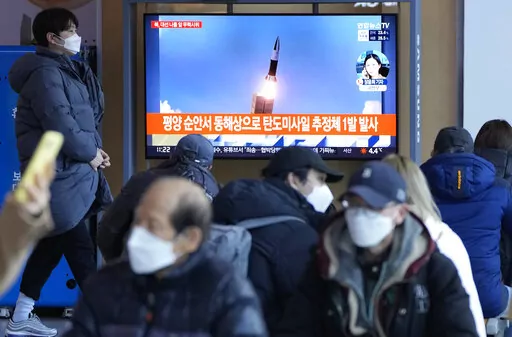 People watch a TV showing a file image of North Korea's missile launch during a news program at the Seoul Railway Station in Seoul, South Korea, March 5, 2022.  The Biden administration says two North Korean missile launches in recent weeks were in fact test-firings of a new intercontinental ballistic missile. And the administration is warning that a full-range test could soon follow. (AP Photo/Ahn Young-joon, File)