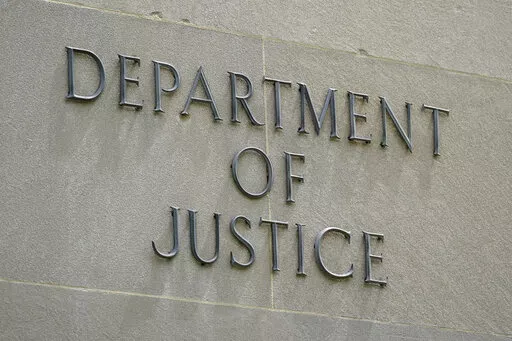 An exterior sign is photographed outside the Robert F. Kennedy Department of Justice building in Washington on May 4, 2021. President Joe Biden is nominating six lawyers to run U.S. attorney’s offices across the country, a diverse group of candidates in the latest picks for the top law enforcement positions. The nominees, being announced by the White House on Wednesday, Jan. 26, 2022, would run the federal prosecutors’ offices in Connecticut, Utah, Montana, Alaska, New Mexico and New Hampshi