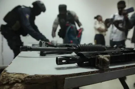 Police display weapons and equipment seized from gangs during a press conference at police headquarters in Port-au-Prince, Haiti, April 26, 2023. (AP Photo/Odelyn Joseph, File)